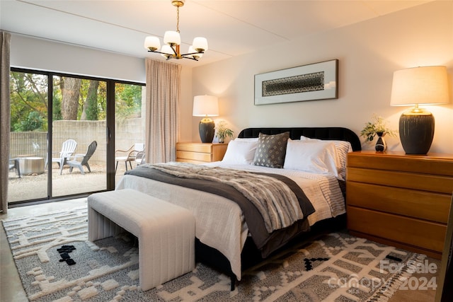 bedroom with access to outside and a chandelier