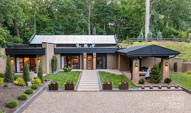 contemporary home featuring a patio and a front yard