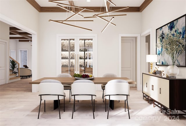 dining room featuring ornamental molding, an inviting chandelier, a towering ceiling, and light hardwood / wood-style floors