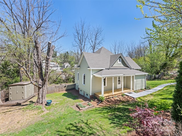 view of front facade with a front yard and a storage shed