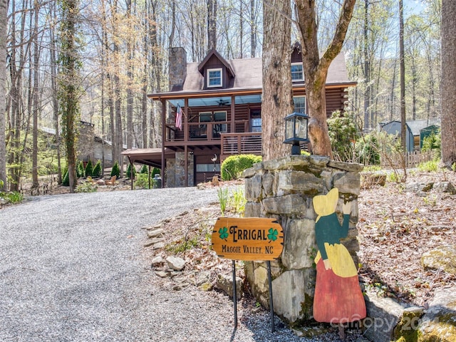 log home featuring ceiling fan