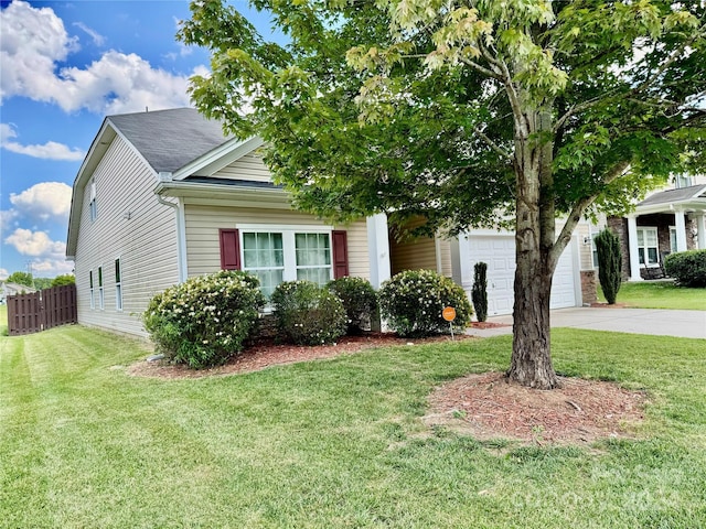 view of front of home with a garage and a front lawn