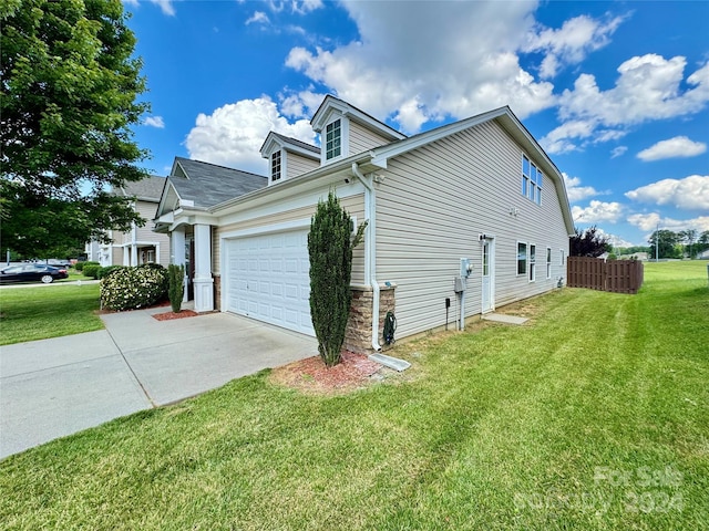 view of home's exterior featuring a yard and a garage