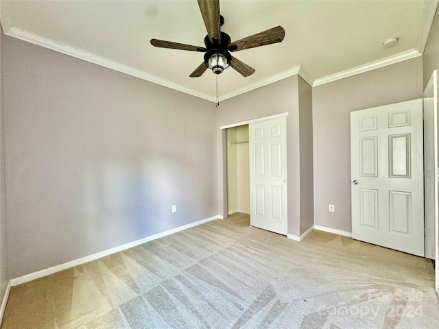 unfurnished bedroom featuring ceiling fan, ornamental molding, and light carpet