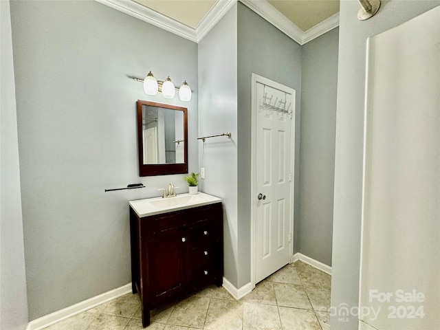 bathroom featuring tile patterned flooring, vanity, and crown molding