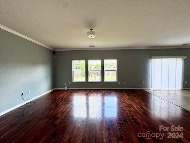 spare room with crown molding and hardwood / wood-style floors