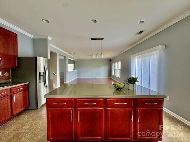 kitchen featuring a center island, crown molding, and stainless steel refrigerator with ice dispenser