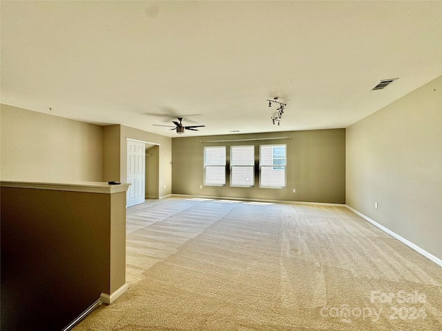 carpeted empty room featuring ceiling fan