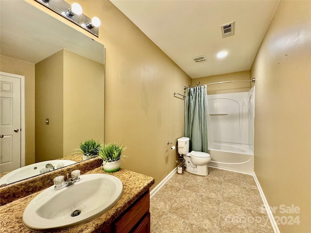 full bathroom featuring shower / bath combo with shower curtain, vanity, and toilet