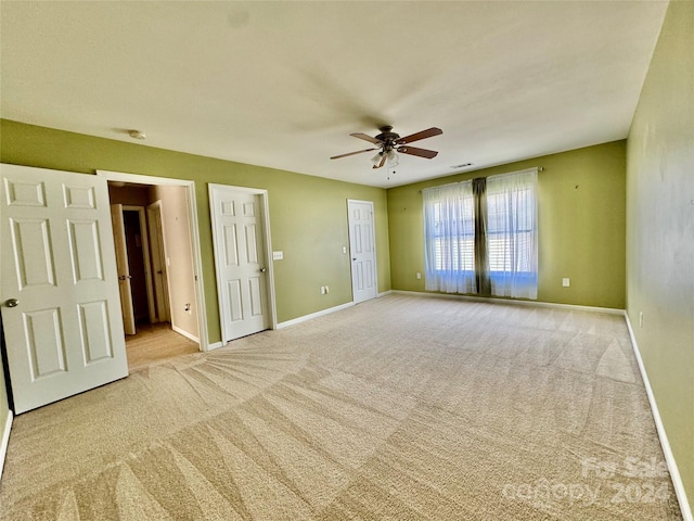 carpeted empty room with ceiling fan