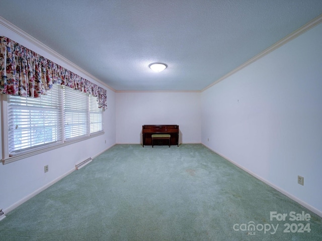 empty room featuring carpet flooring, crown molding, and a baseboard heating unit