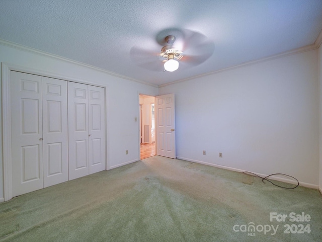 unfurnished bedroom with carpet, ceiling fan, and crown molding