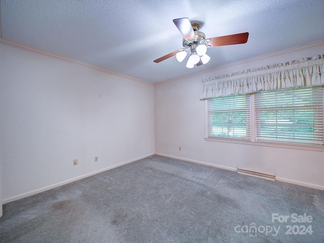 spare room with a textured ceiling, dark carpet, and ceiling fan