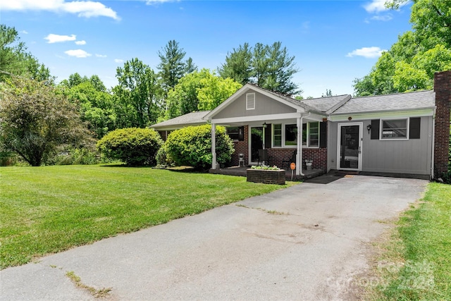 ranch-style home with a front yard and a porch