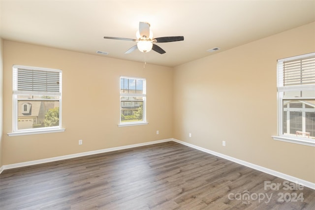 spare room with ceiling fan and dark wood-type flooring