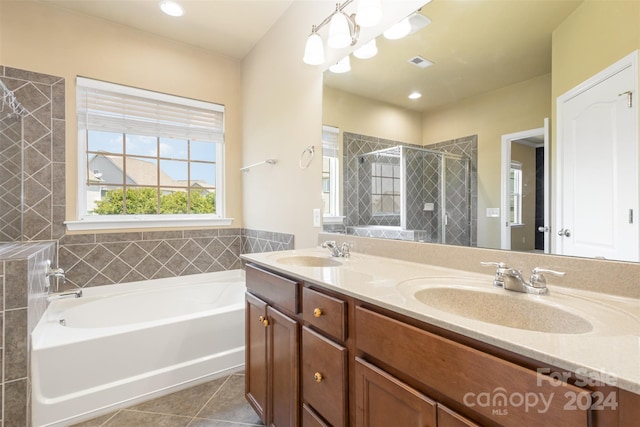 bathroom with tile patterned floors, vanity, plus walk in shower, and a notable chandelier