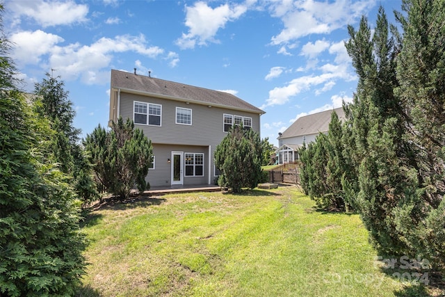 rear view of house with a lawn