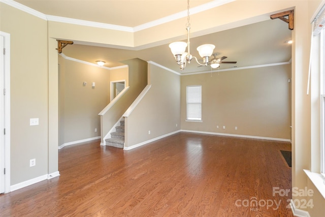 spare room with hardwood / wood-style flooring, ceiling fan with notable chandelier, and ornamental molding