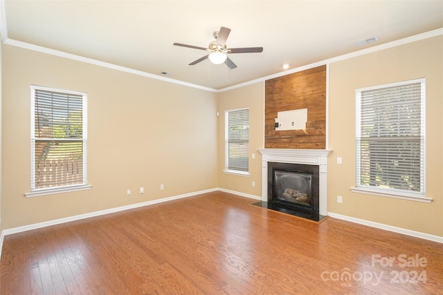 unfurnished living room featuring crown molding, ceiling fan, and hardwood / wood-style flooring