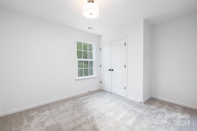 unfurnished room with light colored carpet