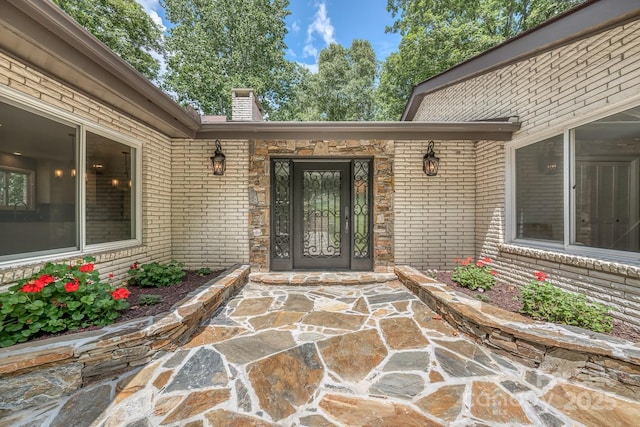 entrance to property featuring a patio