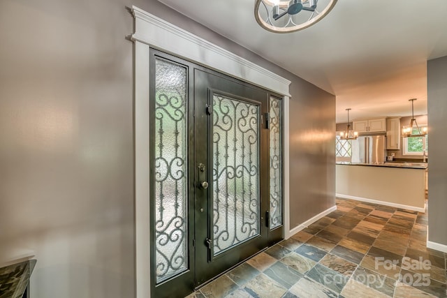 entryway with an inviting chandelier