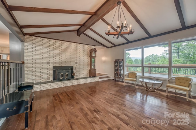 living room featuring wood-type flooring, lofted ceiling with beams, and a chandelier