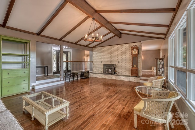 living room featuring an inviting chandelier, hardwood / wood-style floors, and vaulted ceiling with beams