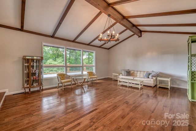 unfurnished living room with lofted ceiling with beams, wood-type flooring, and a notable chandelier