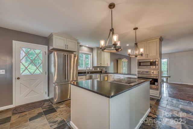 kitchen with pendant lighting, plenty of natural light, stainless steel appliances, and kitchen peninsula