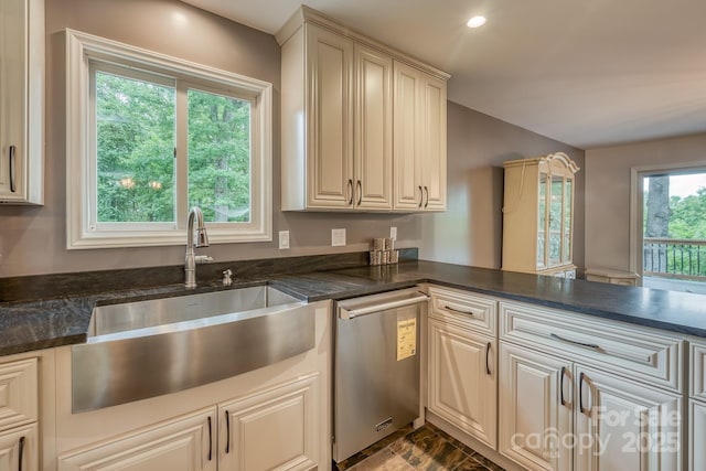 kitchen featuring plenty of natural light, dishwasher, sink, and kitchen peninsula