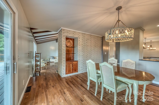 dining area with an inviting chandelier, vaulted ceiling with beams, hardwood / wood-style floors, and brick wall