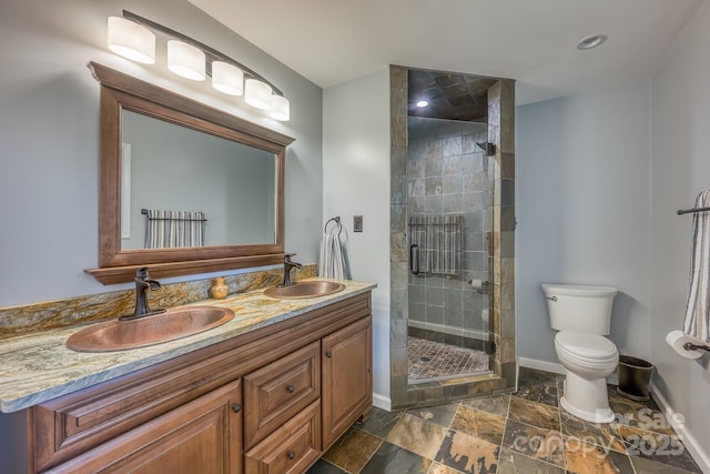 bathroom featuring an enclosed shower, vanity, and toilet