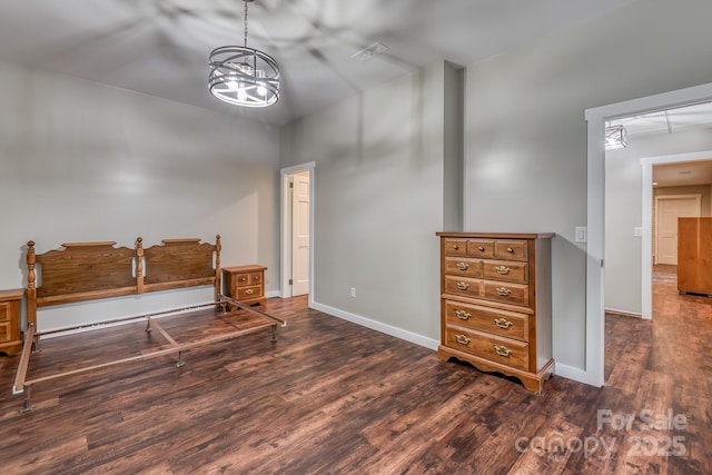 bedroom featuring dark wood-type flooring and a notable chandelier