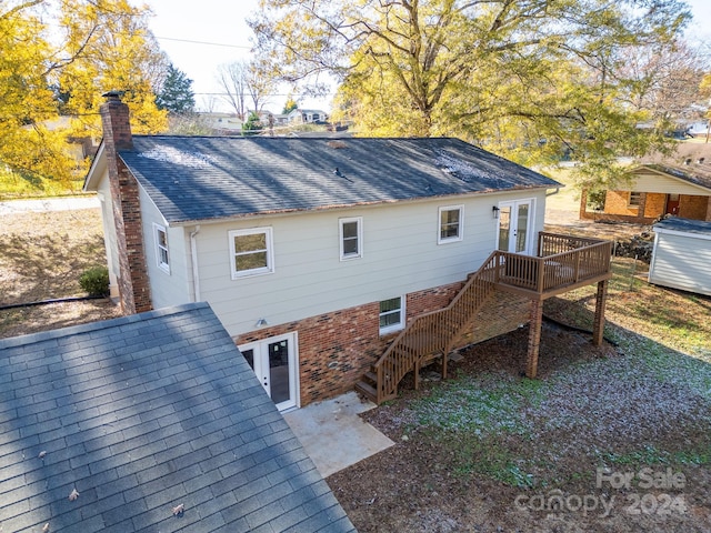 back of property featuring a wooden deck and french doors