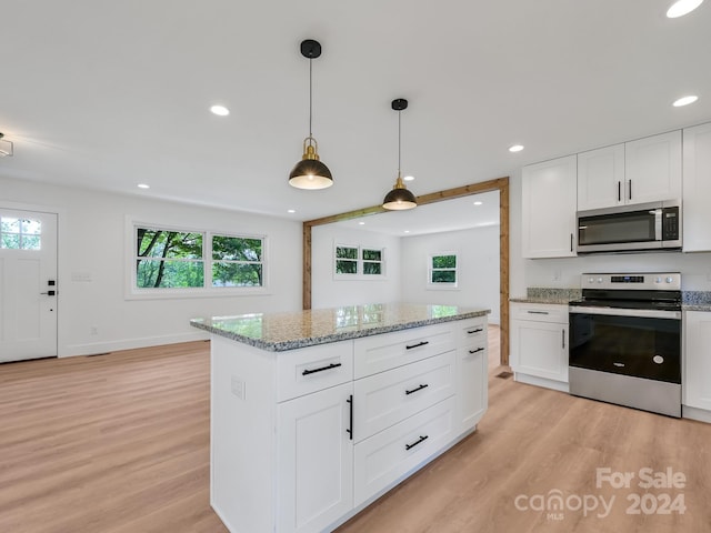 kitchen featuring light stone countertops, white cabinetry, stainless steel appliances, and light hardwood / wood-style floors