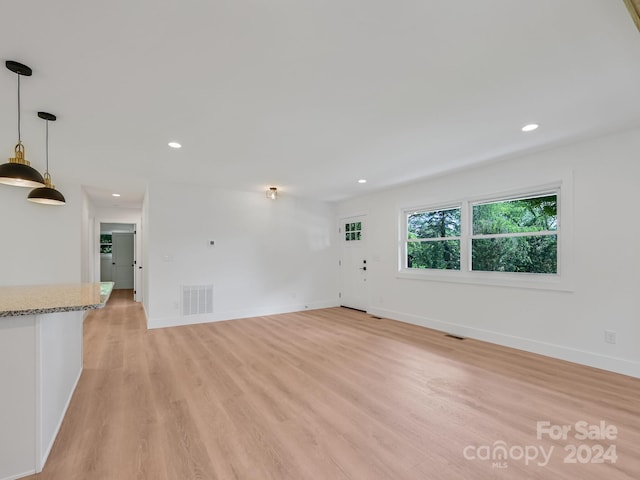 unfurnished living room featuring light wood-type flooring