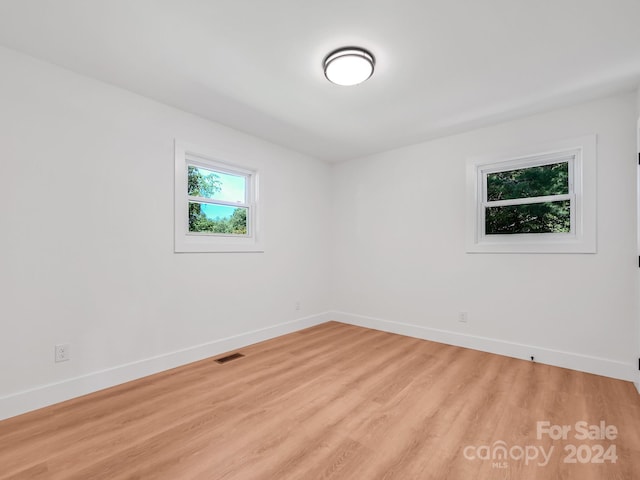 unfurnished room featuring light hardwood / wood-style flooring