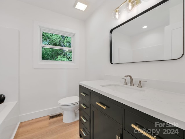 full bathroom with toilet, vanity, bathtub / shower combination, and hardwood / wood-style flooring