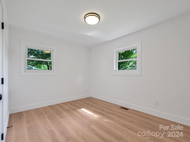 unfurnished room featuring light hardwood / wood-style flooring and a wealth of natural light