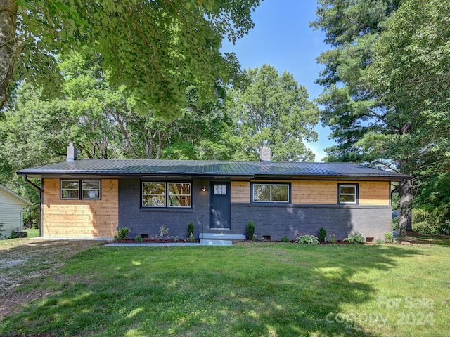 ranch-style home with a front lawn