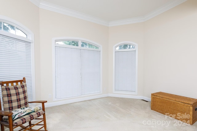 sitting room featuring light carpet, a wealth of natural light, and crown molding