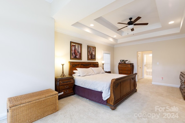 bedroom with light carpet, ensuite bathroom, a raised ceiling, and ceiling fan