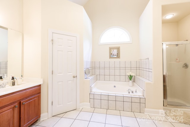 bathroom featuring tile patterned floors, vanity, and shower with separate bathtub