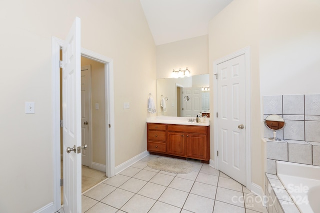 bathroom with vanity, tile patterned floors, lofted ceiling, and tiled tub