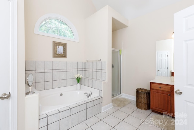 bathroom with tile patterned flooring, vanity, and separate shower and tub