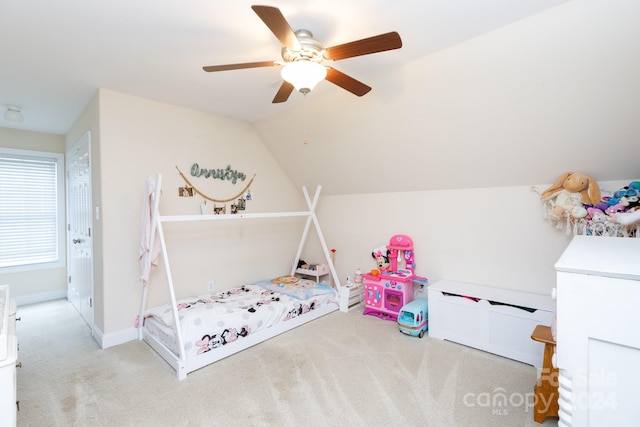 bedroom with ceiling fan, light carpet, and vaulted ceiling