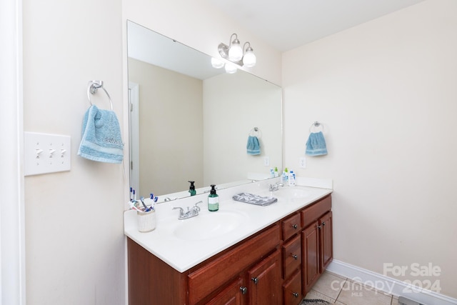 bathroom with tile patterned flooring, vanity, and a notable chandelier