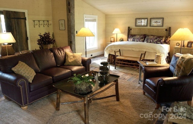 bedroom with hardwood / wood-style floors and vaulted ceiling