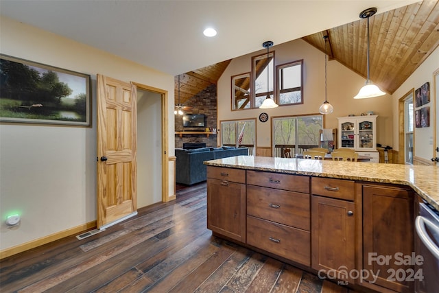 kitchen featuring light stone countertops, dark hardwood / wood-style flooring, pendant lighting, wooden ceiling, and a fireplace